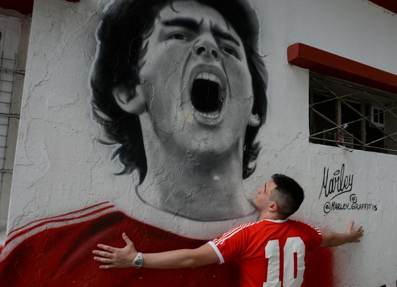 A fan reacts while mourning the death of soccer legend Diego Armando Maradona, outside the Diego Armando Maradona stadium, in Buenos Aires, Argentina November 25, 2020.  REUTERS/Magali Druscovich